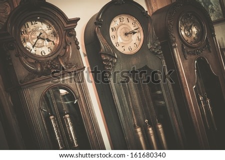 Three vintage wooden floor  clocks