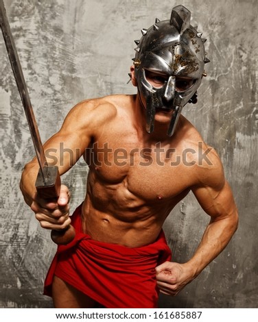 Gladiator with muscular body with sword and helmet
