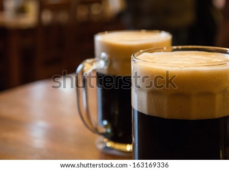 Two Glasses Of Dark Beer On Table