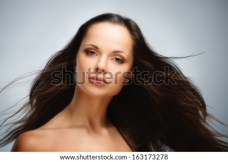 Young beautiful brunette woman with brown eyes and long waving hair