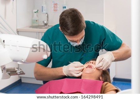 Young woman and man doctor at dentist\'s surgery