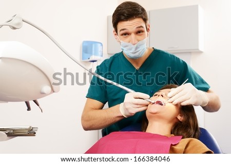 Young woman and man doctor at dentist\'s surgery