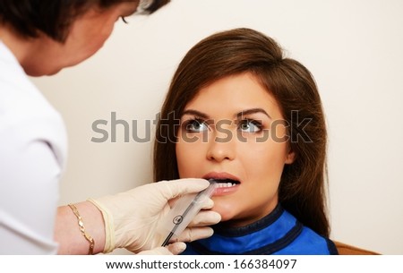 Dentist making x-ray picture of a happy female patient