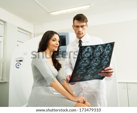 Doctor With Young Woman Patient Looking At The Computed Tomography Results