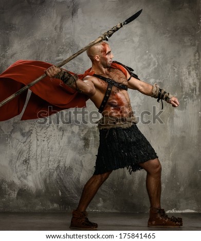 Wounded gladiator in red coat throwing spear