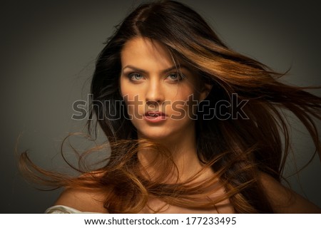 Seductive fatal brunette woman with long hair