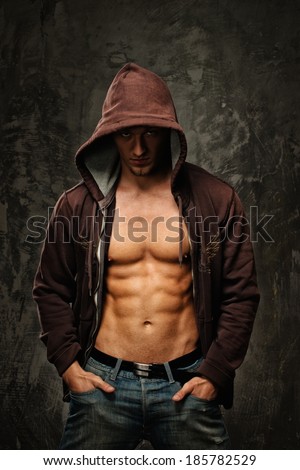 Stylish man with muscular torso wearing hoodie