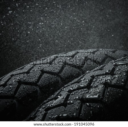 Close-up shots of classical motorcycle tires tread in wet weather condition