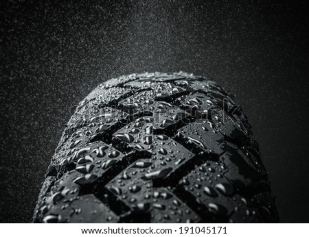 Close-up shot of classical motorcycle tire tread in wet weather condition