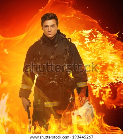 Firefighter with helmet and axe in a flame