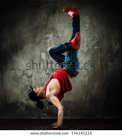 Man dancer showing break-dancing moves