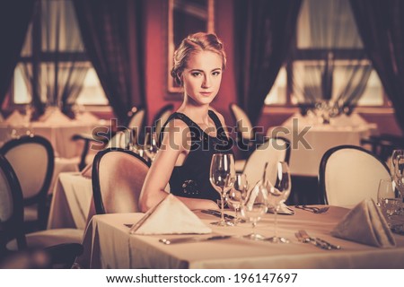 Young beautiful girl alone in a luxury restaurant