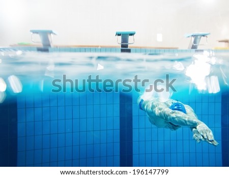 Swimmer under water in swimming pool