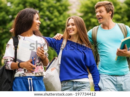 Group of multi ethnic students in a city park on summer day