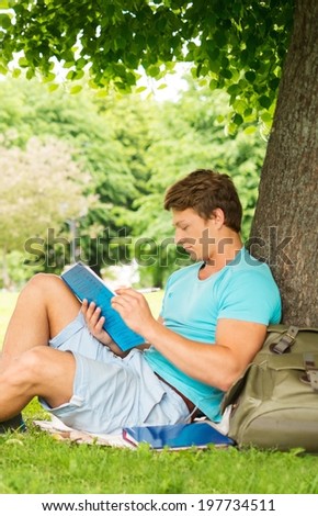 Handsome man student in a city park on summer day
