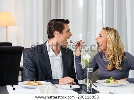 Woman feeding his man in restaurant