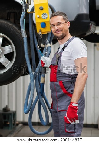 Serviceman in a car workshop