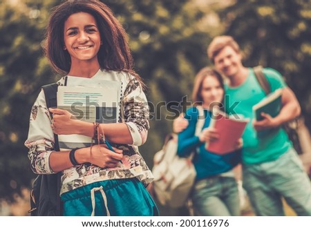 African-american girl student in a city park on summer day