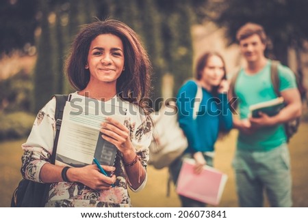African-american girl student in a city park on summer day