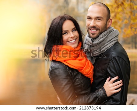 Happy middle-aged couple outdoors on beautiful autumn day