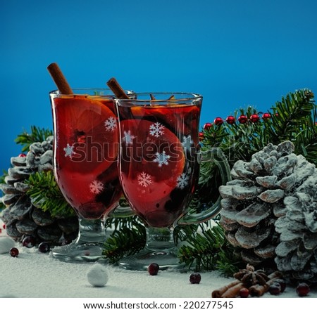 Cups with hot mulled wine in Christmas still life