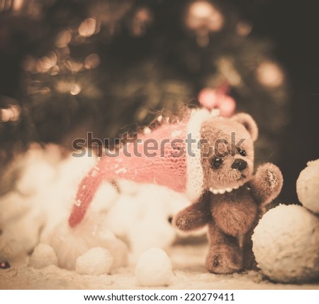 Small toy bear making snowman in christmas still life