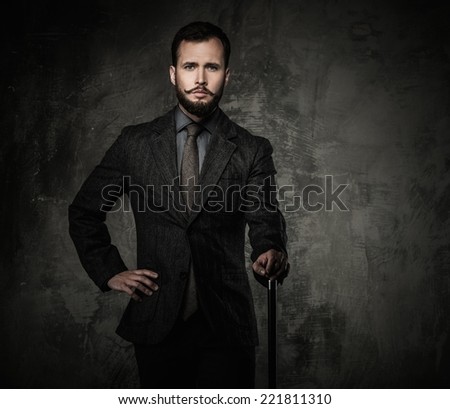 Handsome well-dressed man with walking stick