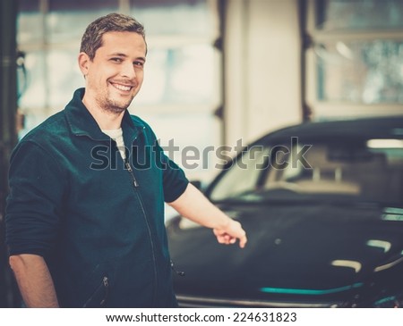 Cheerful man on a car wash