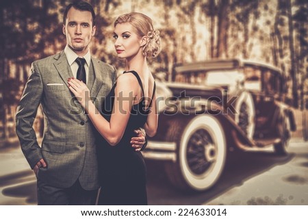 Beautiful retro couple against vintage car