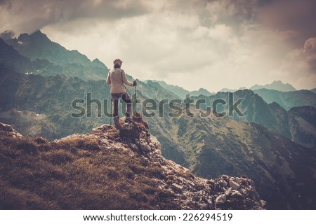 Woman hiker on a top of a mountain