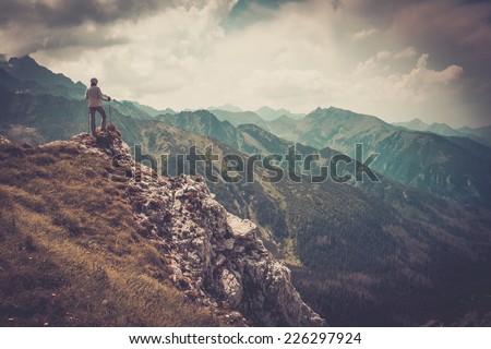 Woman hiker on a top of a mountain Woman hiker on a top of a mountain