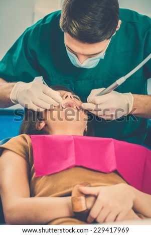 Young woman and man doctor at dentist's surgery