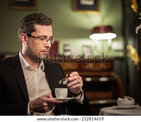 Middle-aged with cup of coffee in luxury vintage style interior