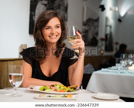 Beautiful young lady alone in restaurant