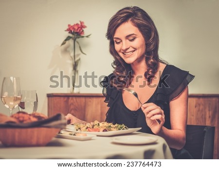 Beautiful young lady alone in restaurant
