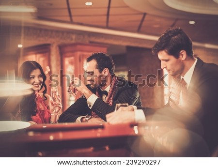People behind poker table in a casino