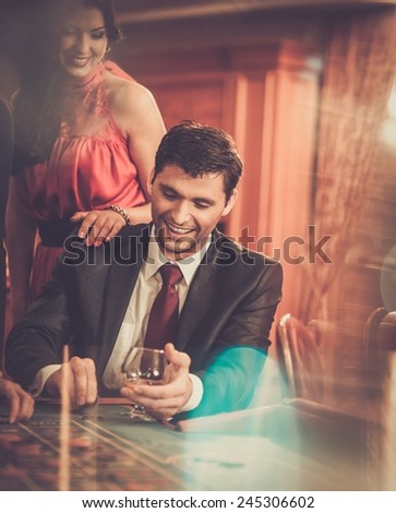 Couple behind poker table in a casino Couple behind poker table in a casino