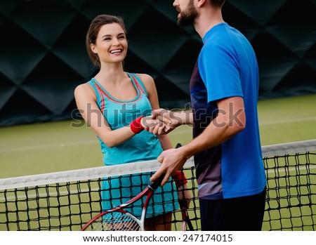 Woman tennis player shaking hand with her coach