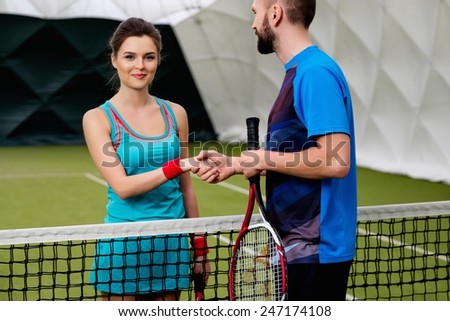 Woman tennis player shaking hand with her coach