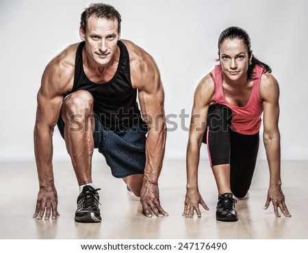 Athletic man and woman doing fitness exercise