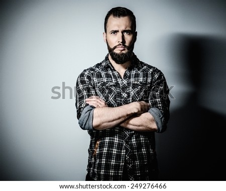 Handsome man with beard wearing checkered shirt Handsome man with beard wearing checkered shirt