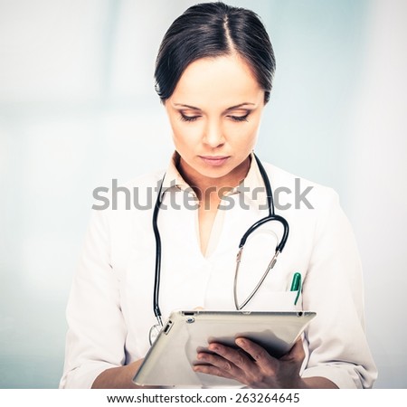 Doctor woman taking notes on tablet pc
