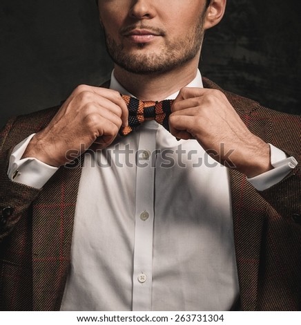 Cheerful sharp dressed fashionist wearing jacket and bow tie