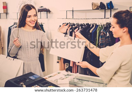Happy customer with shopping bag in fashion showroom