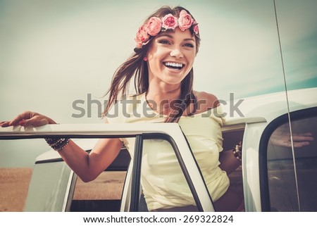 Hippie girl in a van on a road trip