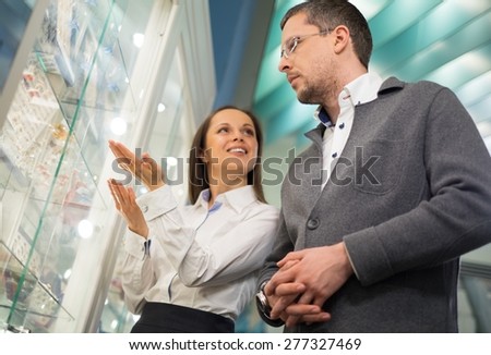 Man with assistant help choosing jewellery