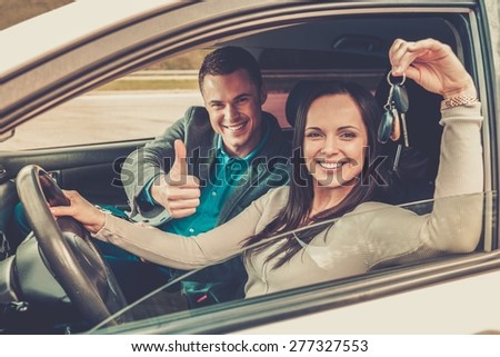 Happy driving student with a car keys