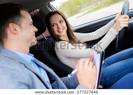 Driving instructor and woman student in examination car