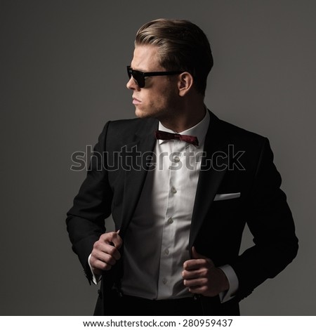 Tough sharp dressed man in black suit