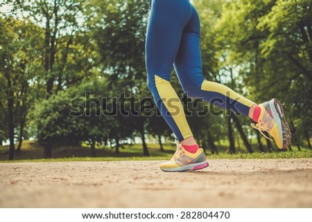 Runner running outdoors wearing sport leggings